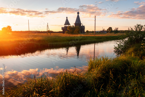 Ancient wooden church in Saunino village near Kargopol at sunrise, Russia