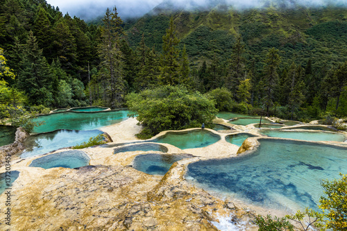 Huanglong National Park, Sichuan, China, famous for its colorful pools formed by calcite deposits. Situated at more than 3000m elevation, it is a UNESCO World heritage site photo