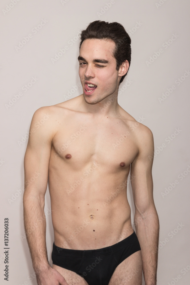 young man shirtless body slim fit winking, tongue out