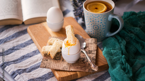 freshly boiled white egg on wooden board. Healthy fitness breakfast