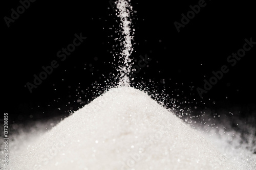 The sugar lies on the black background photo