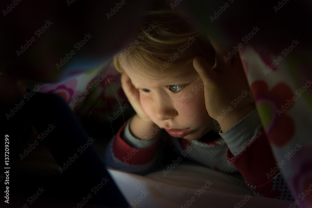 Little Kid in Blanket Staring at Glowing Tablet Screen Little Kid in Blanket Staring at Glowing Tablet Screen