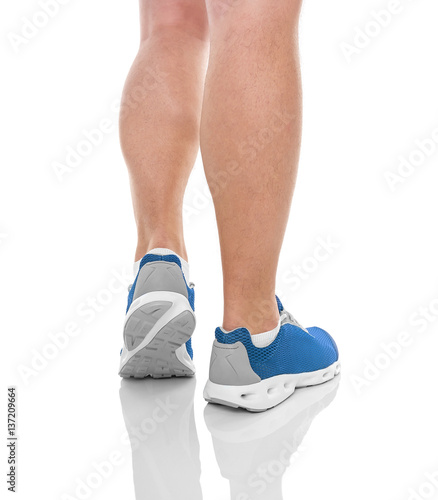 Men's sports legs in sneakers.