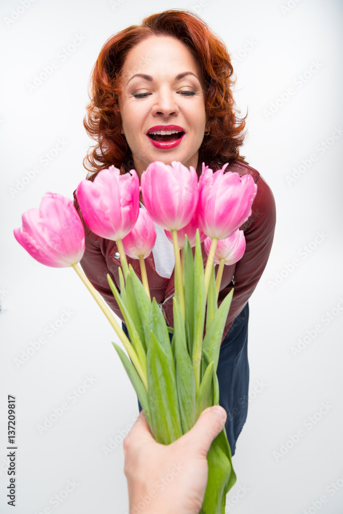 Man presenting flowers to woman Man presenting flowers to woman