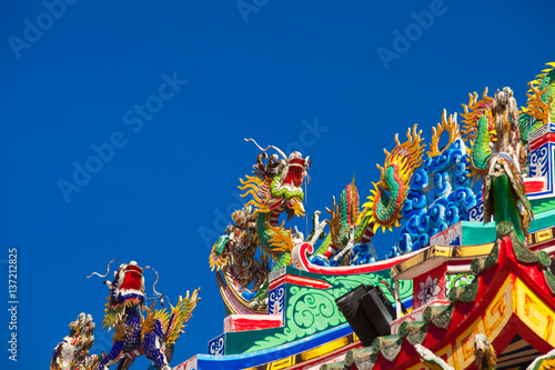 Chinese style dragon statue on blue sky background.