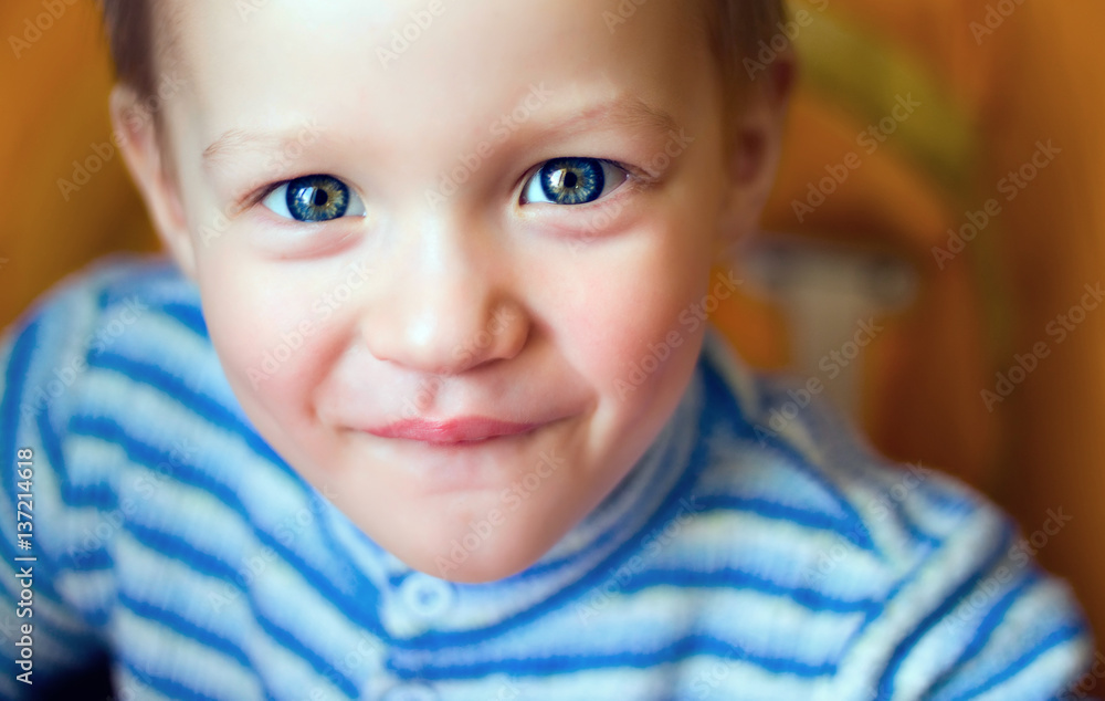 Little boy looking at the camera, blue eyes bright Little boy looking at the camera, blue eyes bright