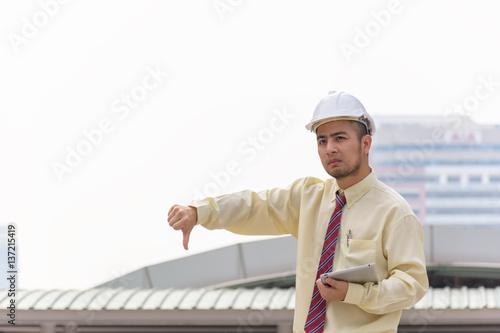 Business man thumbs thumb A confident stance, with the backdrop of the buildings in the city.