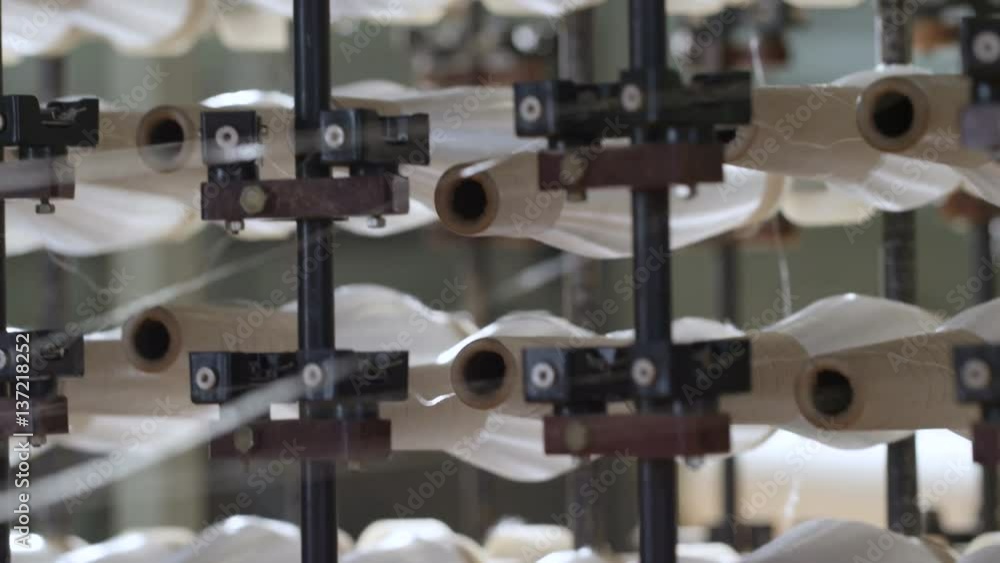 Closeup Operating Spinning Machine with White Thread Bobbins