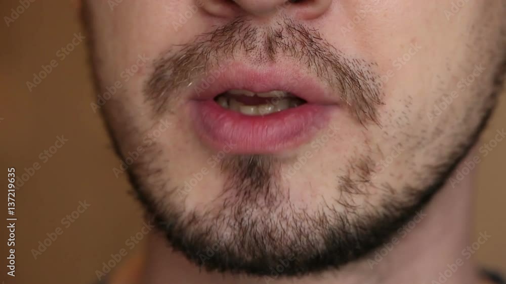 unshaven man says. The lower part of the face close-up unshaven man says. The lower part of the face close-up