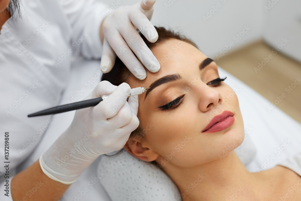 Beautician Doing Permanent Eyebrows Makeup Tattoo On Woman Face Stock Photo | Adobe Stock Beautician Doing Permanent Eyebrows Makeup Tattoo On Woman Face Stock Photo | Adobe Stock