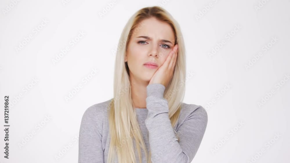 Blonde Woman in gray sweater with severe toothache Blonde Woman in gray sweater with severe toothache