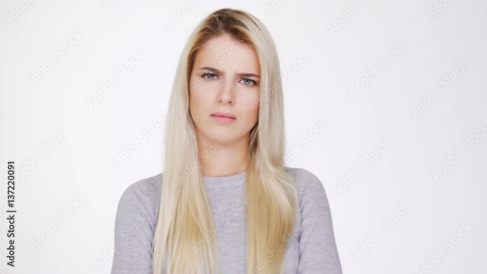 Upset Woman in gray sweater showing thumb down Upset Woman in gray sweater showing thumb down