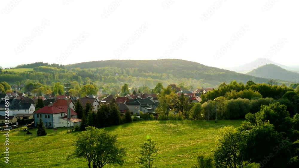 A small village in a hilly area on a bright day - top view A small village in a hilly area on a bright day - top view