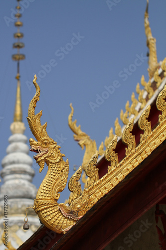 close-up ancient golden colorful dragon horse statue on side of roof top at Thailand national north landmark temple © biggereye