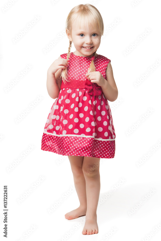 Cute smiling little girl in red dress posing at studio Cute smiling little girl in red dress posing at studio