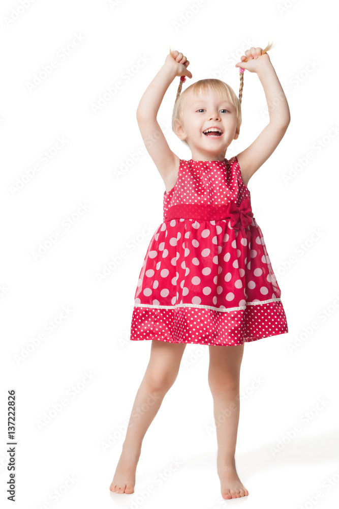 Cute smiling little girl in red dress posing at studio Cute smiling little girl in red dress posing at studio