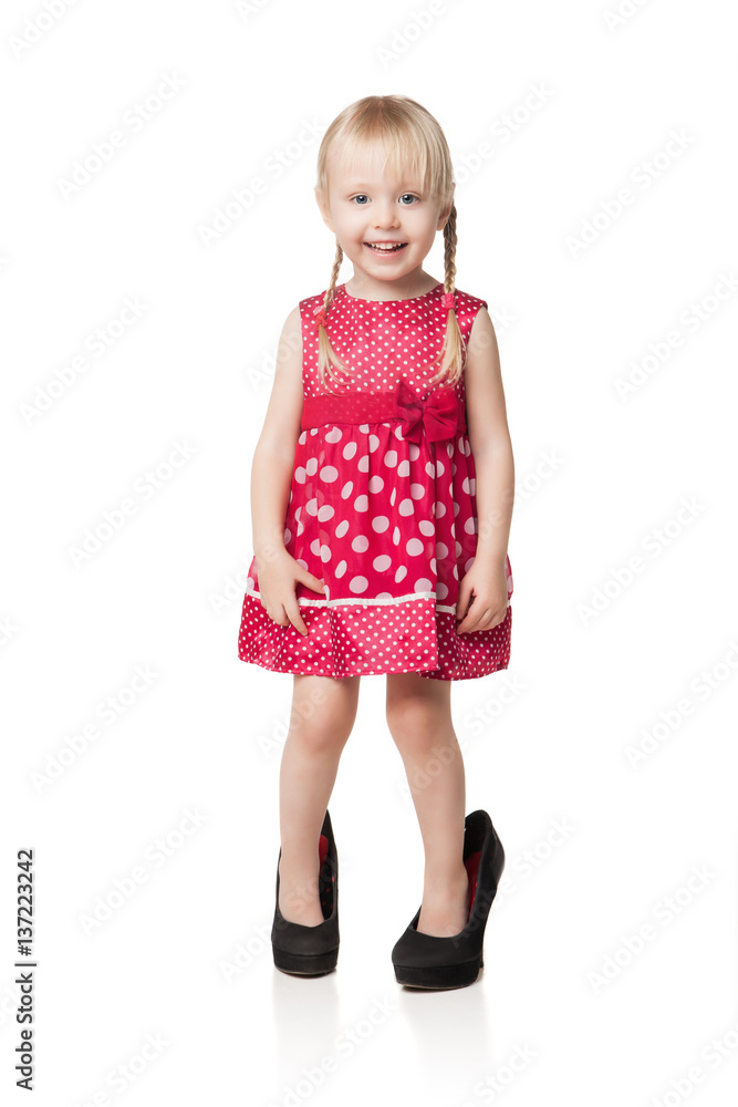Smiling little girl wearing big shoes Smiling little girl wearing big shoes