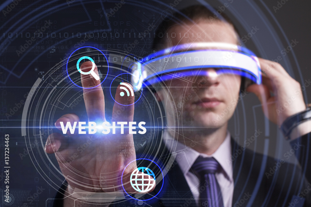 Business, Technology, Internet and network concept. Young businessman working in virtual reality glasses sees the inscription: Web sites Business, Technology, Internet and network concept. Young businessman working in virtual reality glasses sees the inscription: Web sites