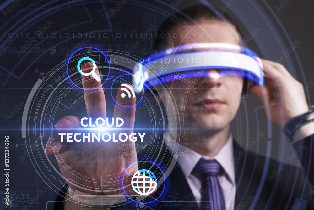 Business, Technology, Internet and network concept. Young businessman working in virtual reality glasses sees the inscription: Cloud technology Business, Technology, Internet and network concept. Young businessman working in virtual reality glasses sees the inscription: Cloud technology