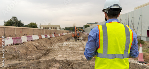 Civil engineer monitoring excavation activities photo