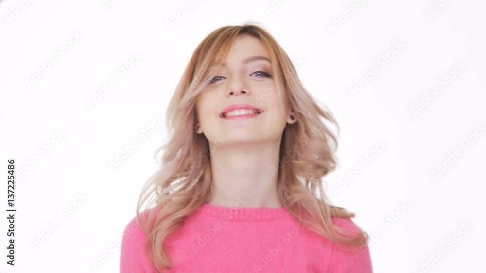 Smiling Woman in pink sweater showing ok sign Smiling Woman in pink sweater showing ok sign