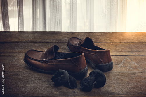 men's shoes and sock on wooden background