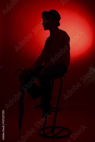 The silhouette of the bride and groom on a red background