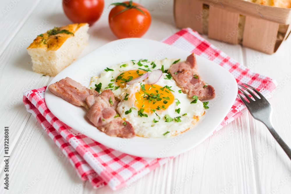 Fried eggs with bacon on white background Fried eggs with bacon on white background