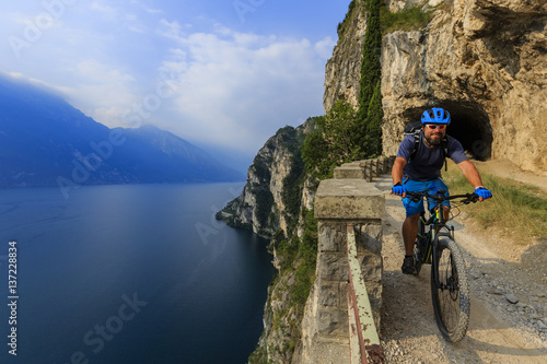 Mountain biking man on Lake Garda, Riva del Garda, Italy
