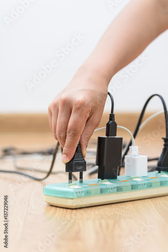 Woman unplugged plug to save on energy