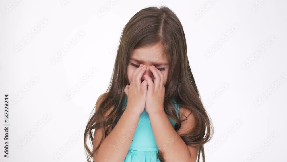 Upset Pretty girl in turquoise dress begins to cry Upset Pretty girl in turquoise dress begins to cry