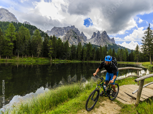 Mountain biking in the Dolomites, Misurina, Italy. Tre Cime di Lavaredo in background.