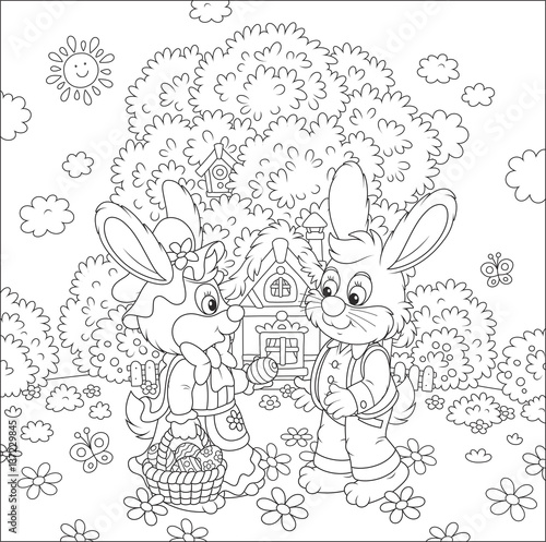Bunnies with a basket of painted eggs in front of their small house on Easter Sunday