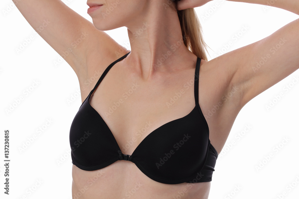 Armpit epilation, laser hair removal. Young woman holding her arms up and showing underarms, smooth clean skin isolated on white background.