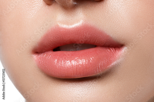 Perfect natural lip makeup. Close up macro photo with beautiful female mouth. Plump full lips.
