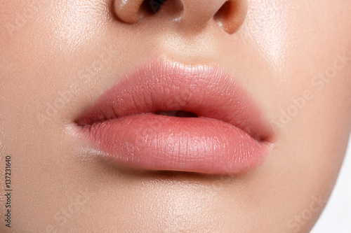 Perfect natural lip makeup. Close up macro photo with beautiful female mouth. Plump full lips.