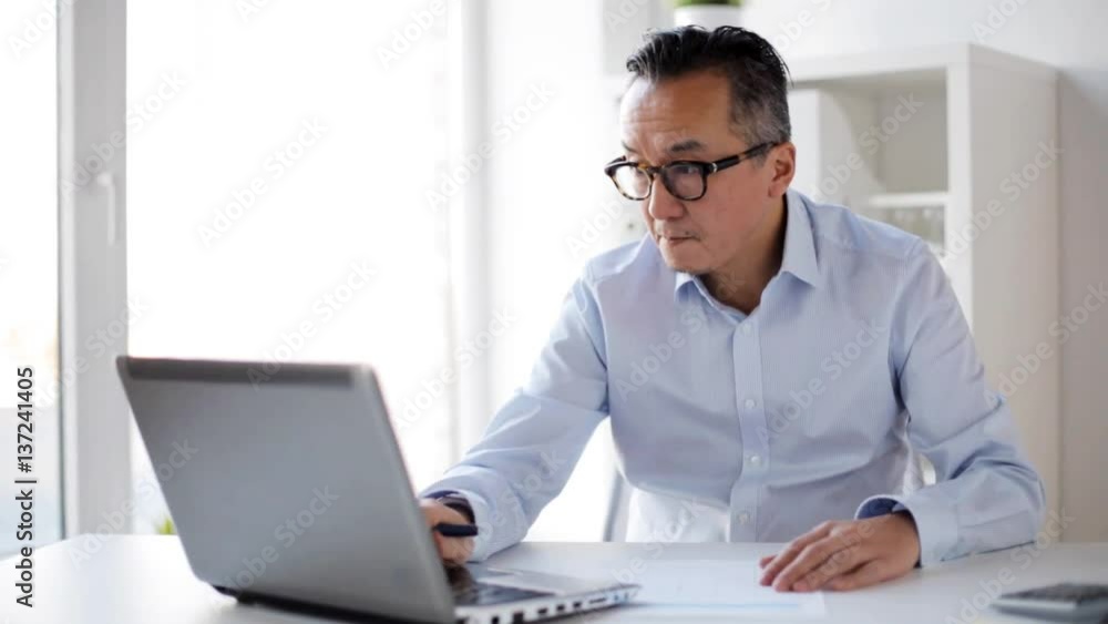 businessman with laptop and papers at office businessman with laptop and papers at office