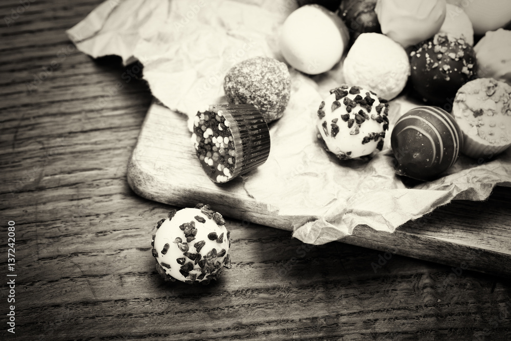 Selection of delicious chocolates on a rustic background Selection of delicious chocolates on a rustic background