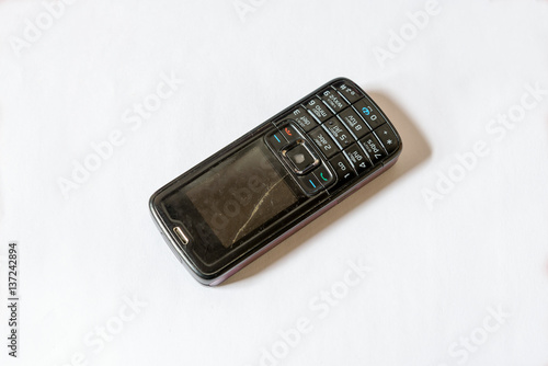 Old broken mobile phone isolated white background