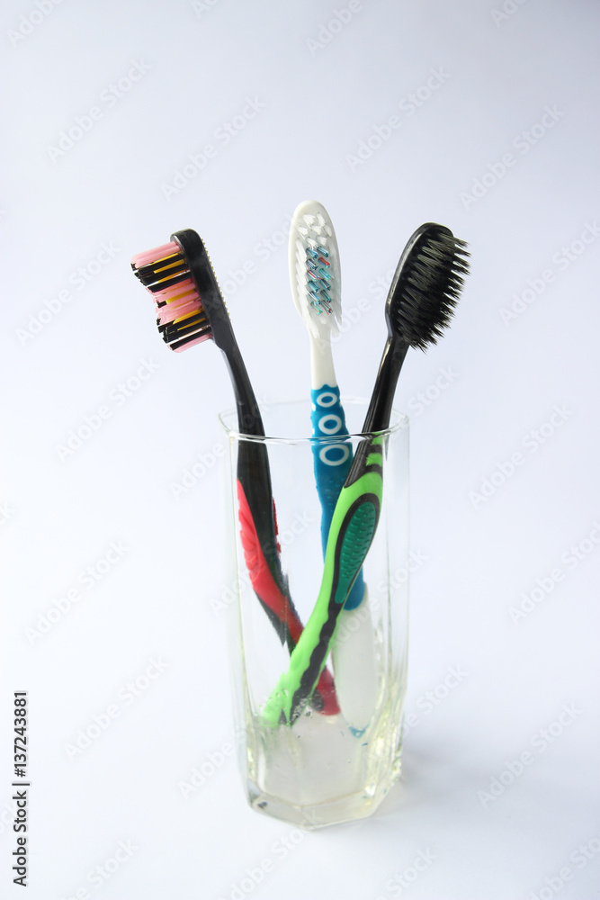 two black toothbrushes and white toothbrush two black toothbrushes and white toothbrush