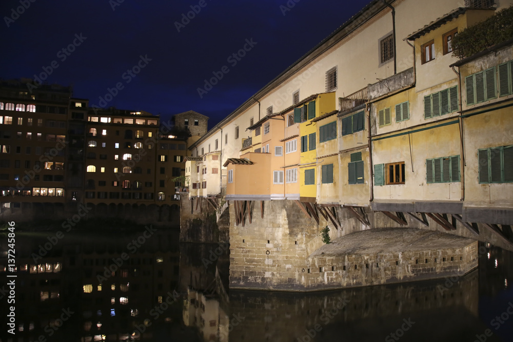 The Ponte Vecchio medieval stone closed-spandrel segmental arch bridge over the Arno River, in Florence, Italy, noted for still