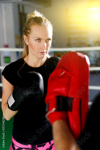 Blonde girl in boxing gloves