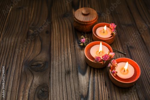 Peach small candles in wooden cups with dried flowers