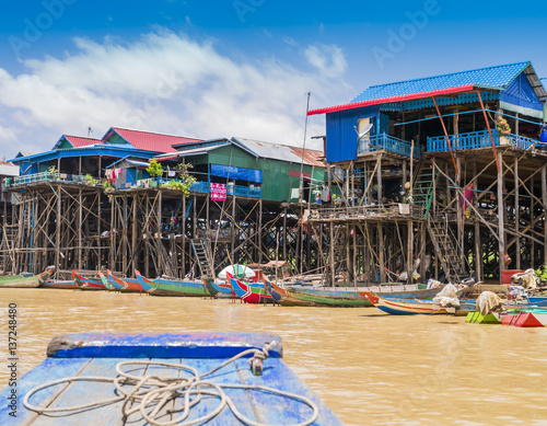 Fototapeta Colorful boats and stilt houses in Kampong Phluk floating village, Tonle Sap lak