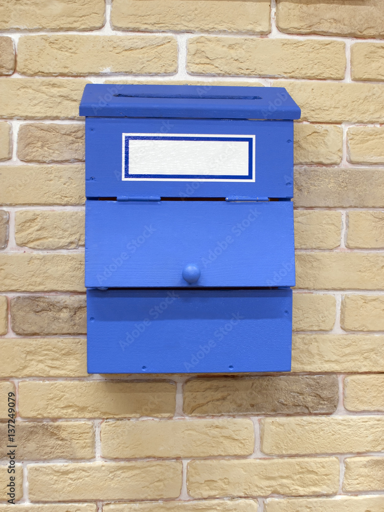 Blue mailbox on the yellow brick wall Blue mailbox on the yellow brick wall