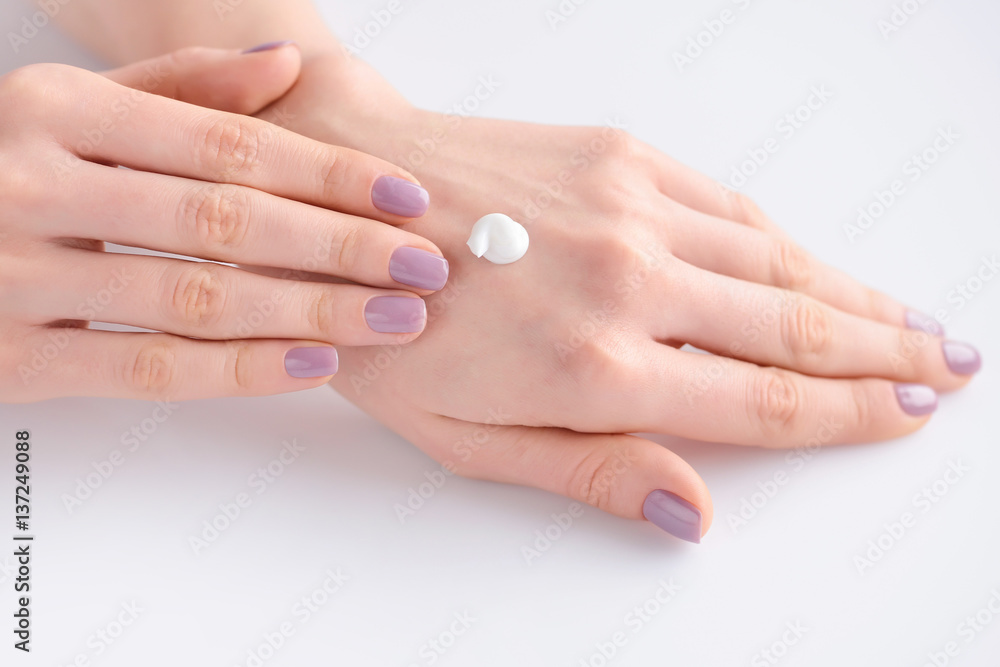 Hands of a woman with pink manicure on nails and pink flowers