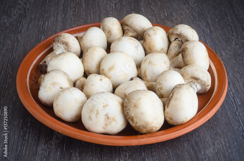 Fresh champignon mushrooms on plate