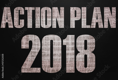 Black chalk board with the text Action plan 2018