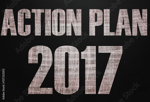 Black chalk board with the text Action plan 2017