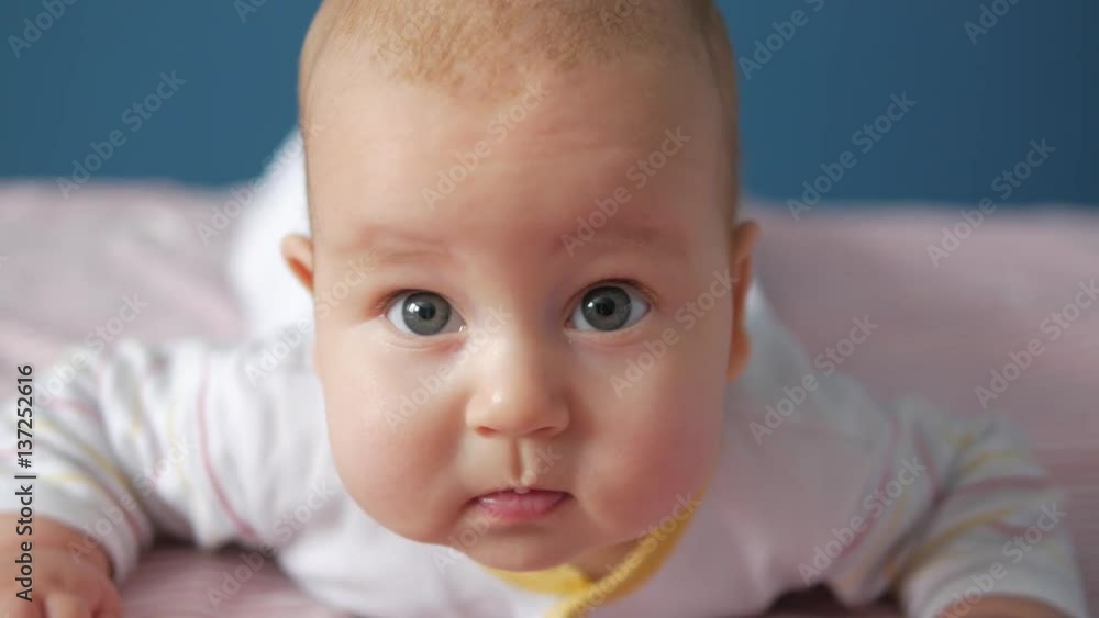Thoughtful baby looking attentevly to the camera. Close up portrait Thoughtful baby looking attentevly to the camera. Close up portrait